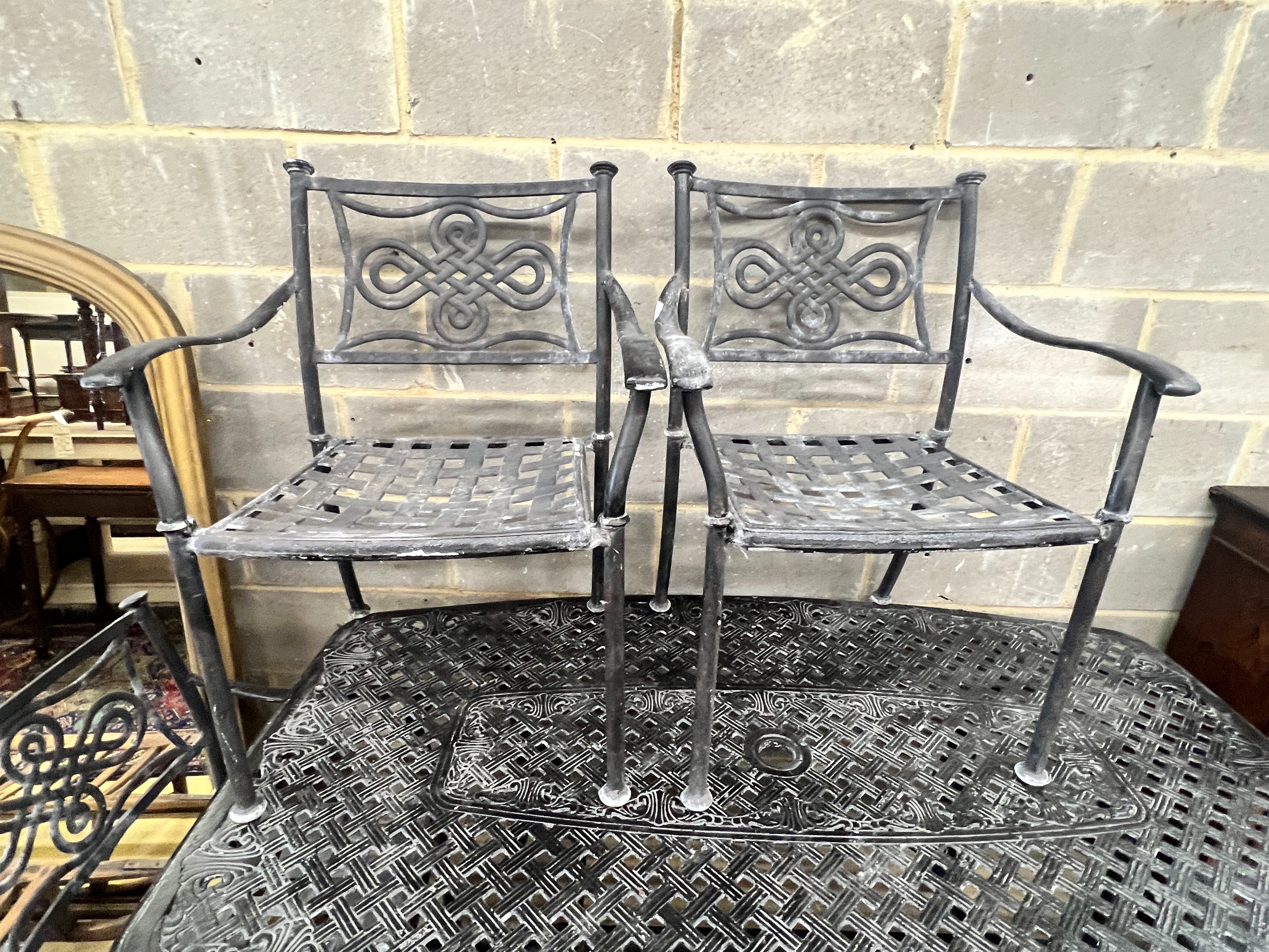 A rectangular painted aluminium garden table, length 164cm, depth 96cm, height 71cm and four similar elbow chairs